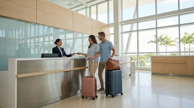 Travelers with luggage waiting in line at a car rental counter inside Miami Airport