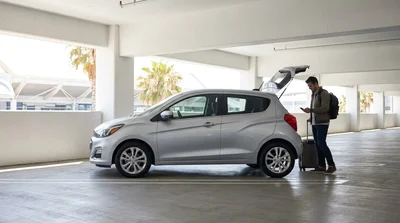 Row of modern vehicles parked inside an airport garage at a San Francisco car rental facility