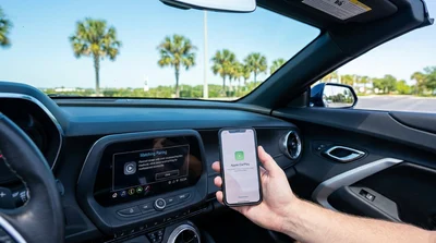 Driver touching an Apple CarPlay infotainment screen in an Orlando car rental vehicle