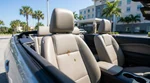 Close up of a dark stain on the passenger seat interior of a Florida car rental