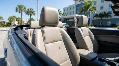 Close up of a dark stain on the passenger seat interior of a Florida car rental