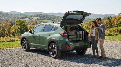 Open trunk of a compact SUV car rental filled with suitcases parked outdoors in Pennsylvania