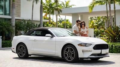 Couple driving a white car rental along a scenic coastal highway in sunny Florida