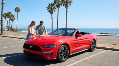 White car hire driving along a sunny scenic coastal highway in California with ocean views