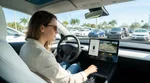 Person inspecting the rear bumper and reversing camera of a car rental in a sunny Florida parking lot