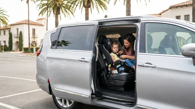 Toddler safely buckled into a child seat inside a California car rental