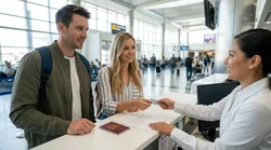 Customer handing a credit card to a clerk at a car rental desk in the United States