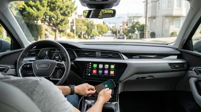 Apple CarPlay displayed on a car rental dashboard screen with San Francisco streets visible through the windshield