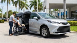 A person in a wheelchair entering an adapted car rental parked near a beach in Florida