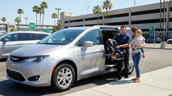 Parent securing a child seat in the back of a car hire vehicle on a sunny Orlando street