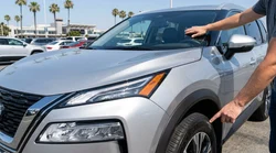 White car rental driving on a scenic highway in California with a clear view of the windscreen and tyres