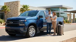 Customer handing a credit card to an agent at a car rental desk in Texas