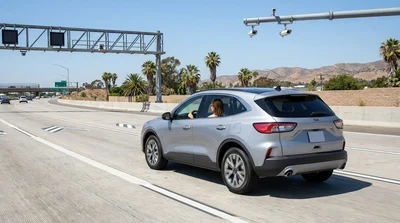 White car rental driving in the Metro ExpressLanes on a sunny Los Angeles freeway