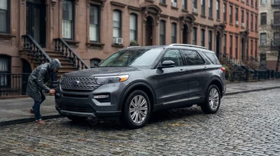 A shiny car rental parked on a New York street with a clear view of the windscreen and tyres