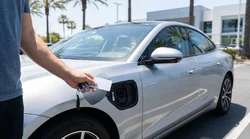 Person using an RFID card at a public charging station for an electric car rental in California