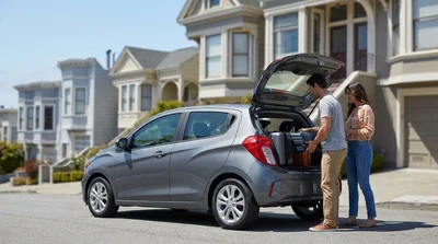 Silver car rental parked on a steep hill overlooking the downtown San Francisco skyline