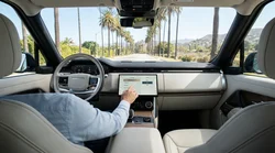 Driver adjusting the dashboard touchscreen display in a car rental parked in California