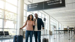 Customer approaching the Hola car rental desk inside the Orlando airport terminal
