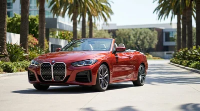 Black luxury car rental driving down a sunny palm-lined street in Los Angeles