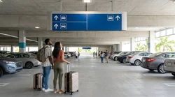 Cars driving toward the exit lanes of a Miami car rental facility