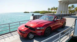 White car rental parked on a ferry deck crossing bright blue water in the Florida Keys