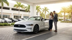 Customer handing a credit card to an agent at a car rental desk in Miami