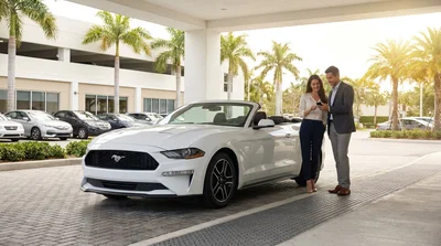 Customer handing a credit card to an agent at a car rental desk in Miami