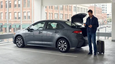 Close up of a person handing a credit card to an agent at a New York car hire counter