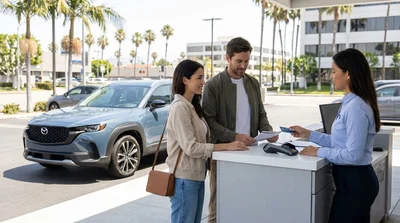 Customer handing a credit card to an agent at a Los Angeles car rental counter