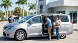 Parent fitting a child seat into a car hire vehicle at a Florida airport parking lot