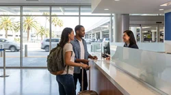 Traveler handing documents to a clerk at a San Francisco car rental desk