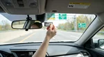 E-ZPass tag mounted on the windshield inside a car rental driving on a Pennsylvania highway