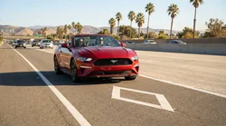 Two people driving a car rental in an HOV carpool lane on a California highway