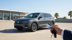 Customer handing a credit card to an agent at a car rental counter in Texas