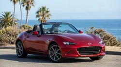 Person driving a convertible car hire along a sunny coastal road in California