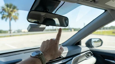 Close-up of a toll transponder attached to the windshield of a Florida car rental