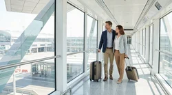 Passengers with luggage walking into an airport car rental center in San Francisco