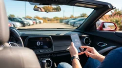 Driver connecting a smartphone to the dashboard screen inside a Texas car rental vehicle