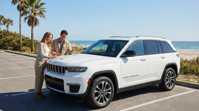 A white convertible car rental parked with a view of the ocean after a drive from Orlando