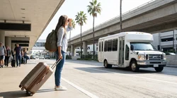 People with luggage boarding a car rental shuttle outside LAX Terminal 8 in Los Angeles