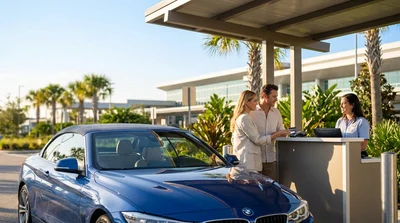 Close up of a customer handing a credit card to an agent at an Orlando car hire desk