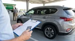 Customer paying with a credit card at a car rental desk in the United States