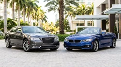 Sleek black luxury car rental parked along a sunny palm tree-lined street in Miami