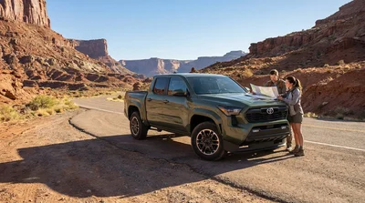 Silver 4x4 SUV car hire driving along a scenic desert highway in the United Estates