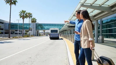 Hola shuttle bus parked outside the terminal at Miami Airport for car rental passengers