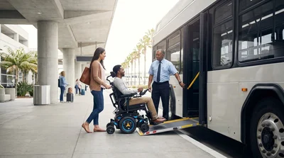 Wheelchair user boarding a car rental shuttle bus using a deployed ramp at the San Francisco airport