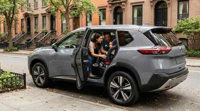 Child safety seat installed in the back of a car rental parked on a New York street
