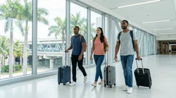 Passengers walking on a bright walkway connecting the Metrorail to the car hire center in Miami