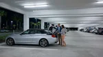 Traveler receiving keys at a brightly lit car hire desk inside Orlando airport at night
