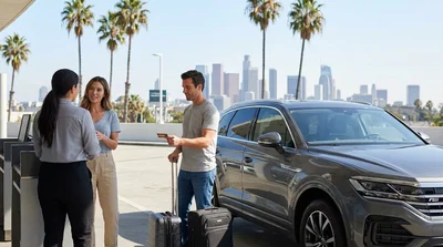 Customer handing a credit card to a car rental agent across a counter in Los Angeles